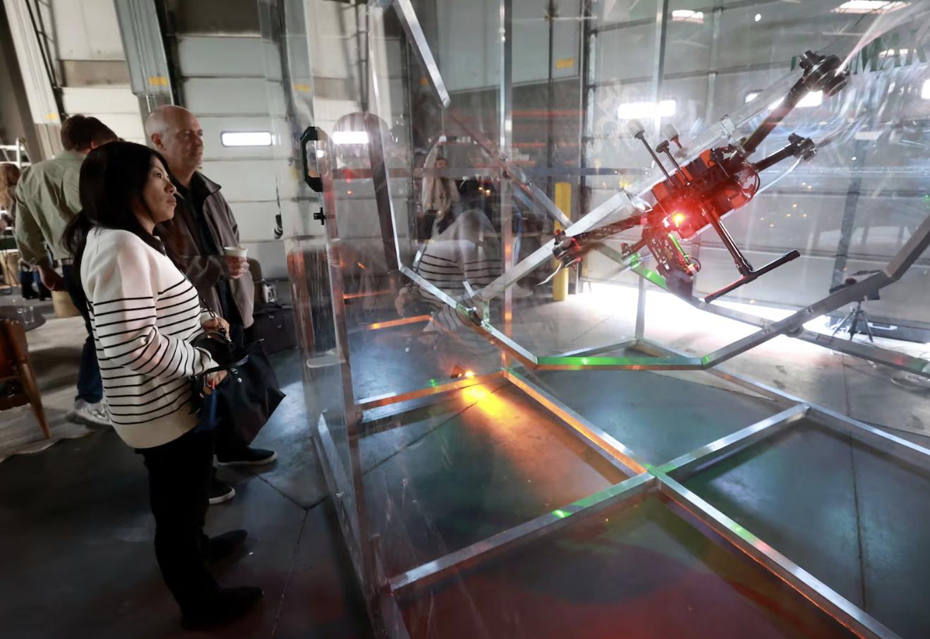 Eriko Imai, from NEC Corporation in Japan, and David Jorty, Rainmaker meteorologist, watch an Elijah drone demonstration during a kickoff event for Rainmaker Technology Corporation’s Bear River Basin cloud seeding program at Rainmaker in Salt Lake City on Nov. 7.