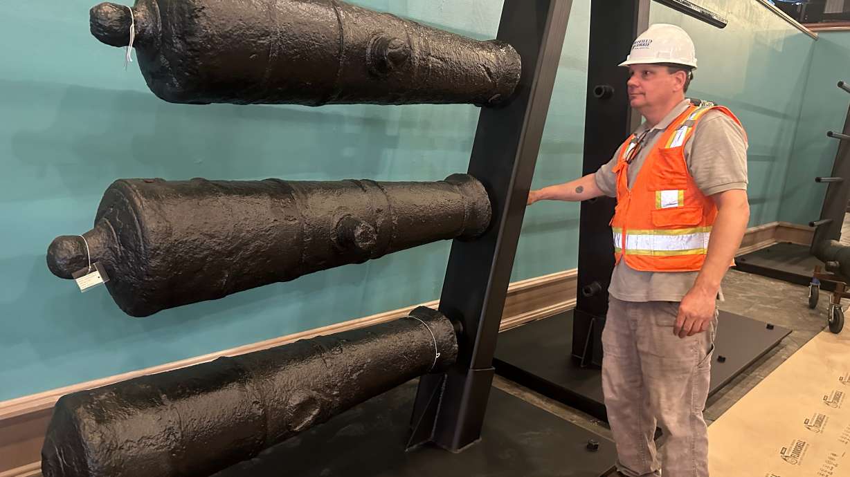 Terry Koeller inspects cannons, which sunk to the bottom of the Savannah River during the American Revolution, on a rack at the Savannah History Museum in Savannah, Ga., on Wednesday.