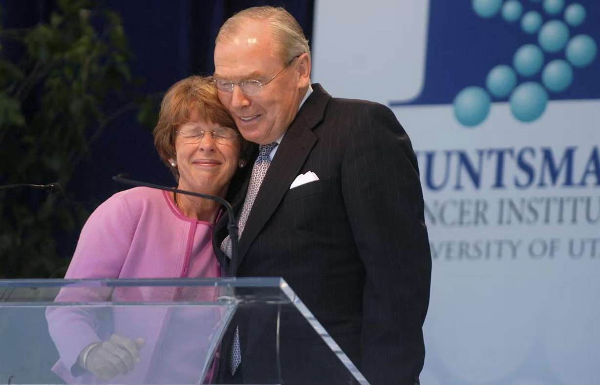 Karen Huntsman, left, embraces her husband Jon Huntsman Sr. following her remarks at the dedication of the new Huntsman Cancer Institute in Salt Lake City on June 21, 2004.