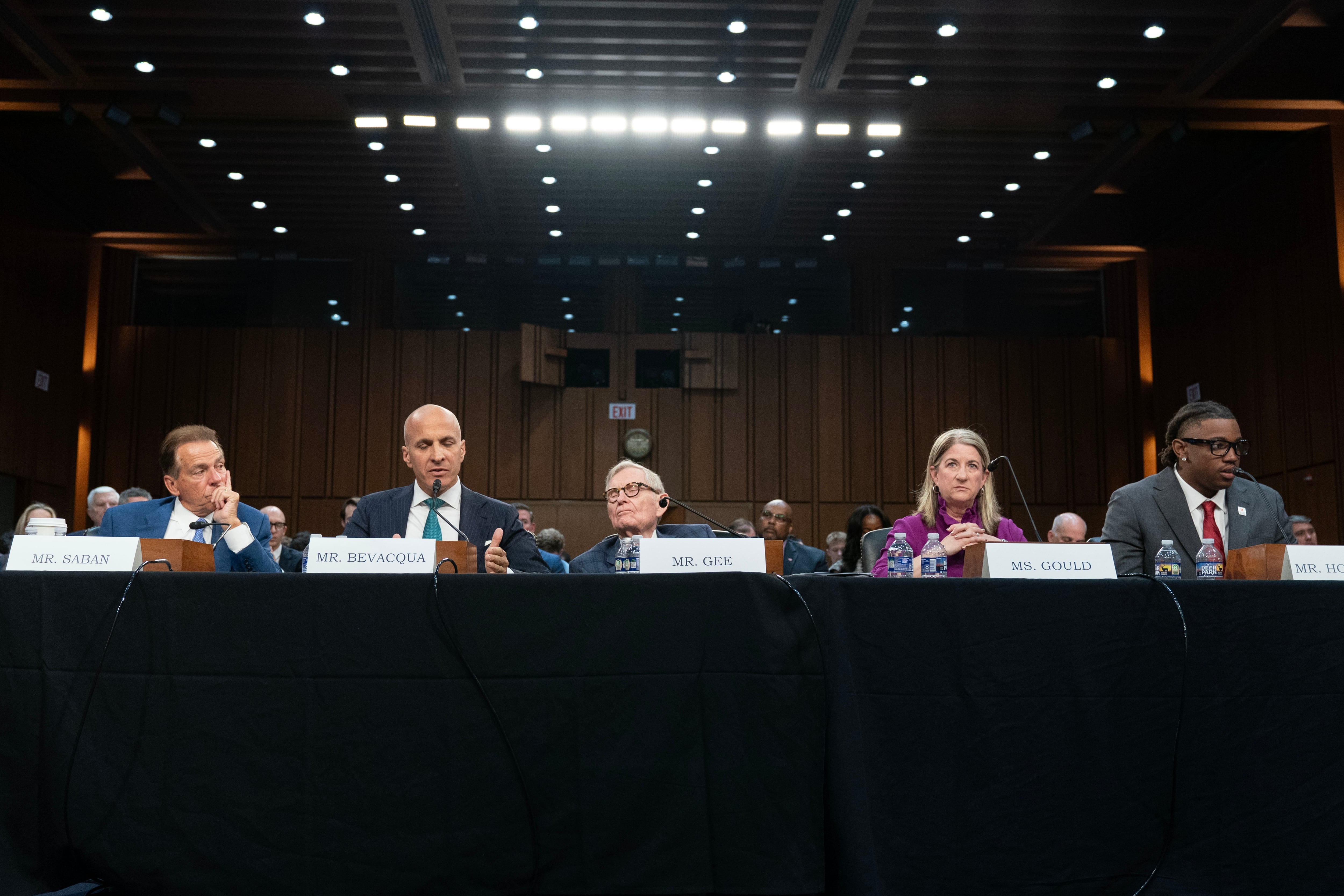 Former Alabama football coach Nick Saban, Notre Dame Director of Athletics Pete Bevacqua, West Virginia University President Gordon Gee, Pac-12 Commissioner Teresa Gould, and University of Utah student athlete Lance Holtzclaw testify before the Senate Committee on Commerce, Science, and Transportation, Wednesday, in Washington. The hearing came as senators consider the Protect College Sports Act.