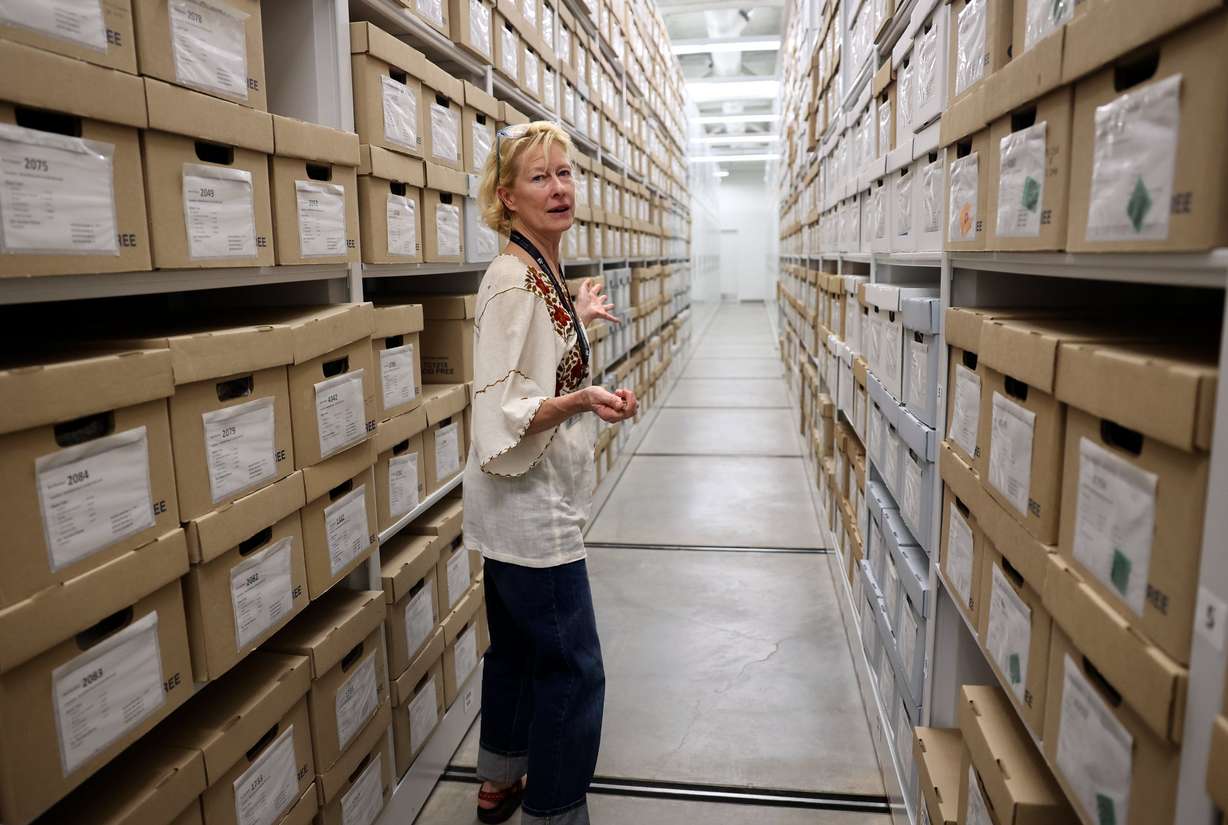 Anne Lawlor, Natural History Museum of Utah anthropology collections manager, walks through stacks of boxes looking for Indigenous items that are part of the Cerberus Project at the NHMU in Salt Lake City on May 29. More than 100,000 Indigenous items were recovered in a federal undercover operation and the Utah BLM and NHMU are cataloging the artifacts and returning them to tribal nations when possible.