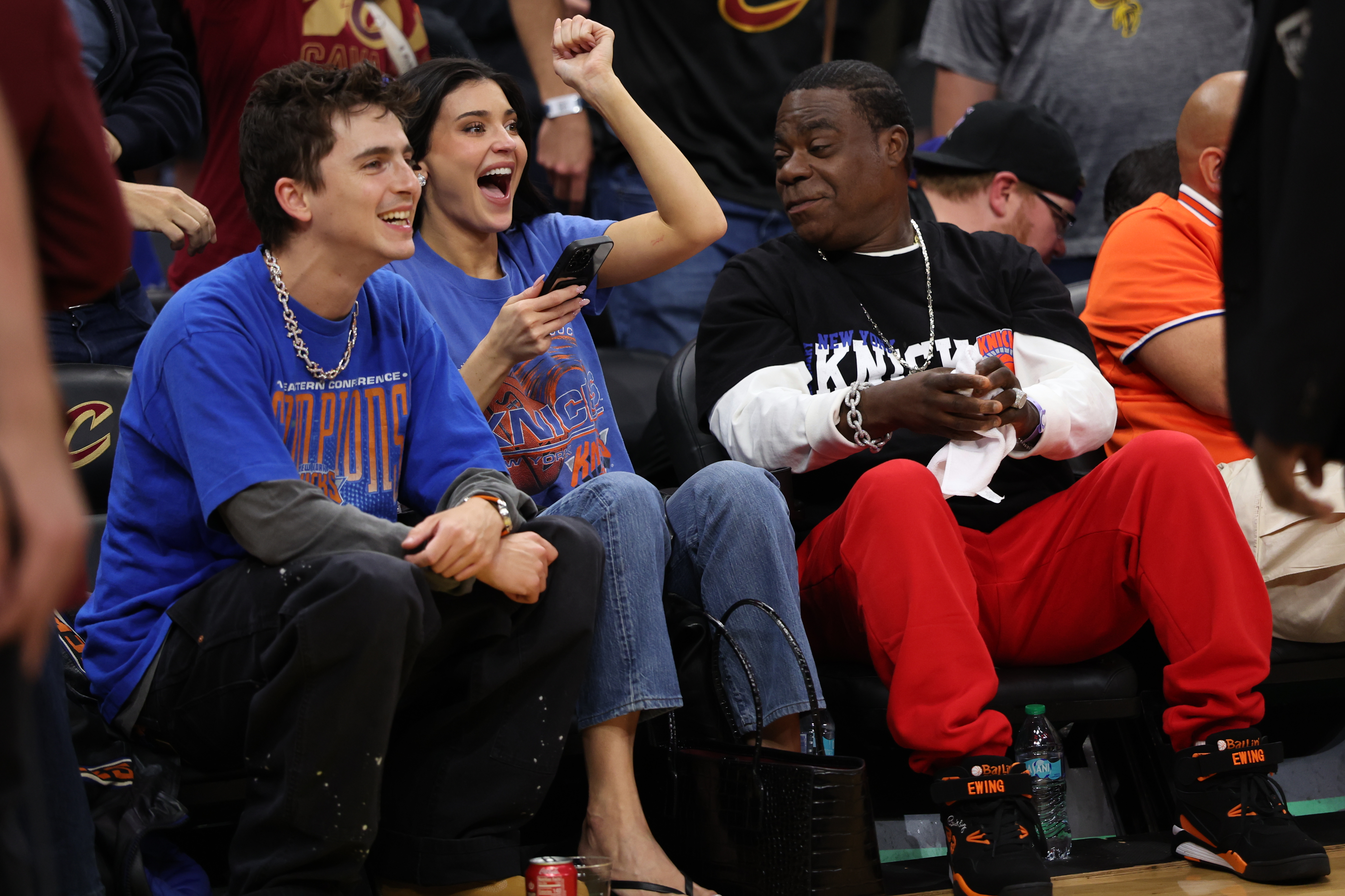 Timothée Chalamet, left, Kylie Jenner, center, and Tracy Morgan watch the second half of Game 4 in the Eastern Conference finals NBA basketball playoffs series between the New York Knicks and the Cleveland Cavaliers in Cleveland, Monday, May 25, 2026. 