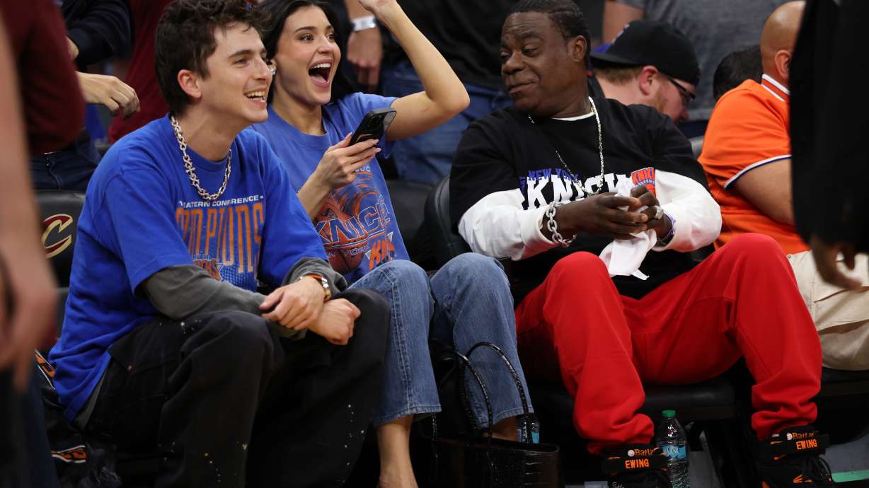 Timothée Chalamet, left, Kylie Jenner, center, and Tracy Morgan watch the second half of Game 4 in the Eastern Conference finals NBA basketball playoffs series between the New York Knicks and the Cleveland Cavaliers in Cleveland, Monday, May 25, 2026.