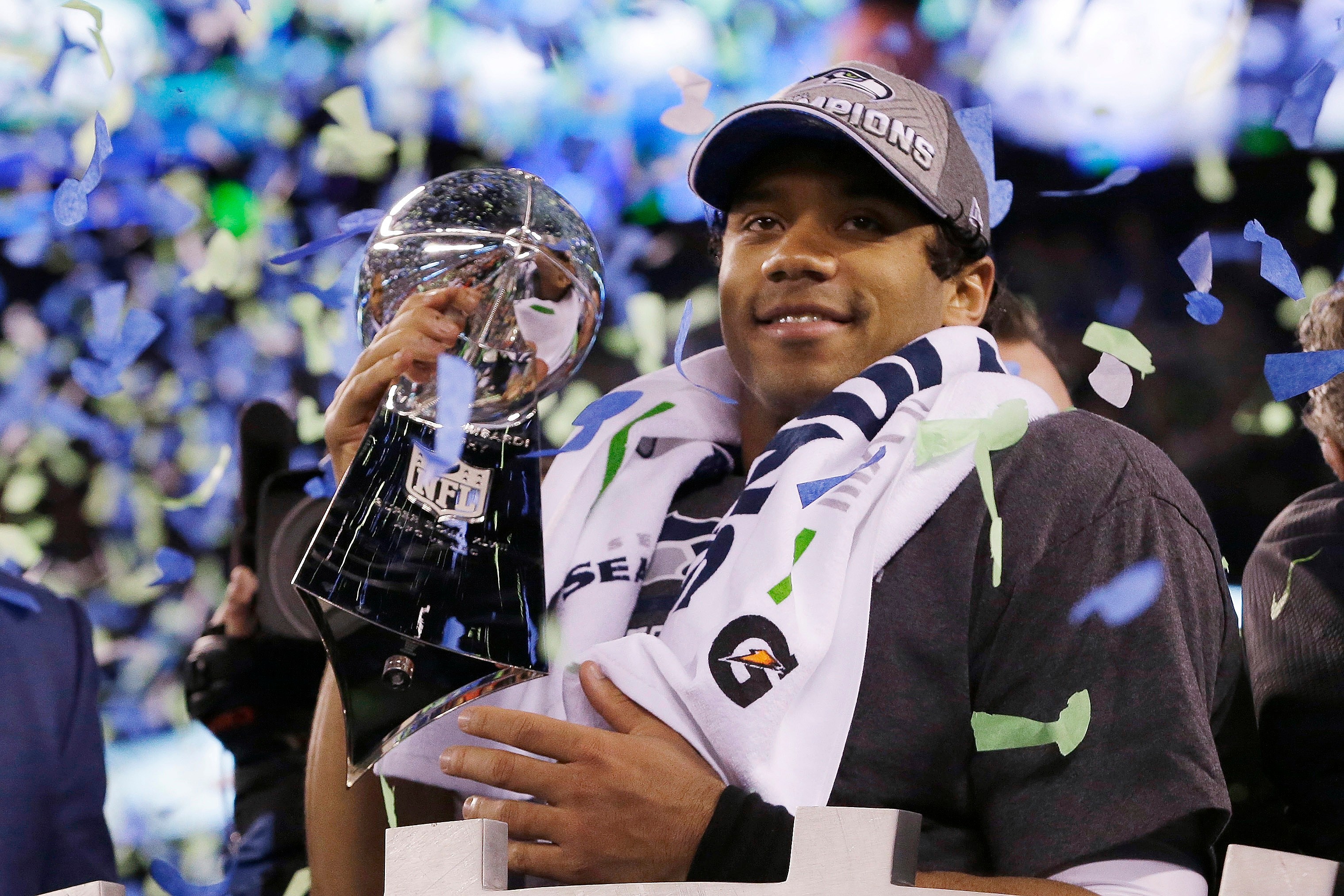 FILE - Seattle Seahawks' quarterback Russell Wilson holds the Lombardi Trophy after the NFL Super Bowl XLVIII football game, Feb. 2, 2014, in East Rutherford, N.J. 