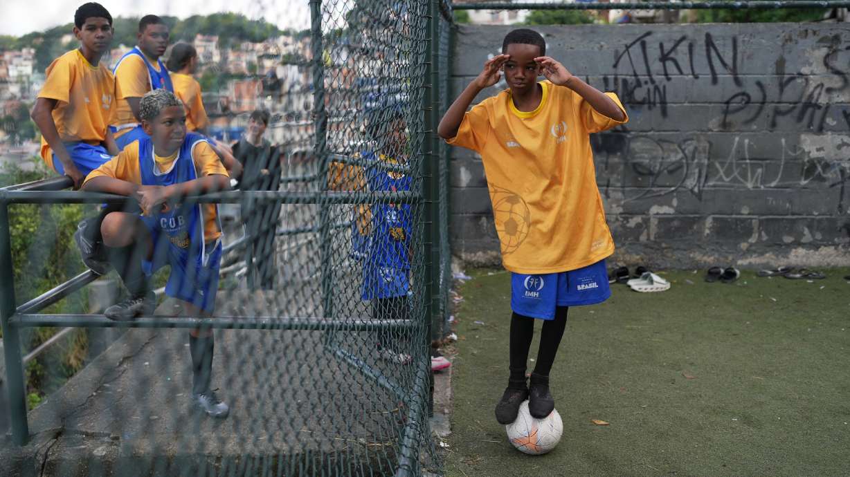 Luis Gustavo balances on a ball during a soccer training session organized by the Street Child United Brazil social project in the Complexo da Penha favela of Rio de Janeiro, Wednesday, June 3, 2026.