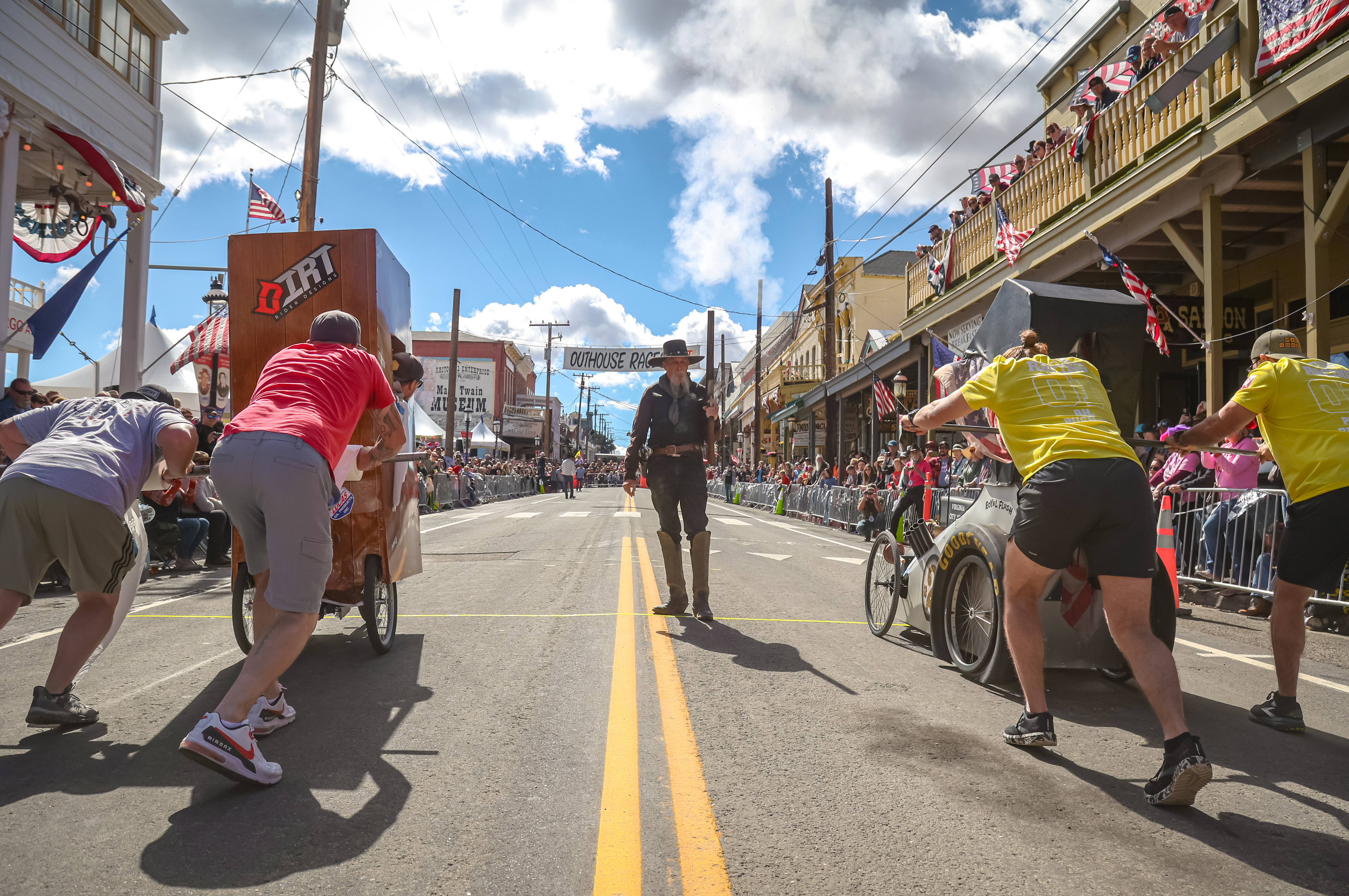 Teams race custom-built outhouses down historic C Street.