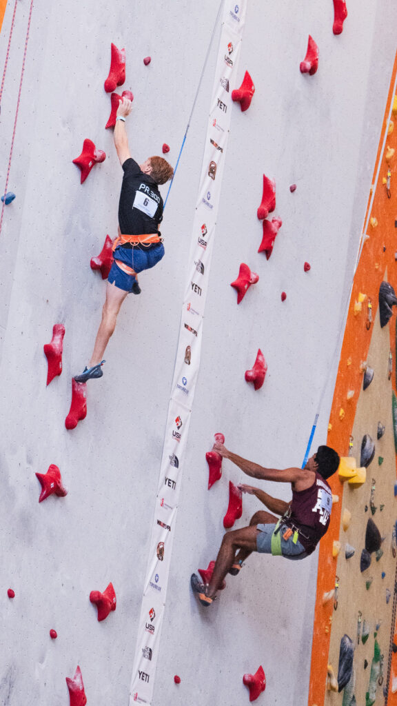 U student Logan Miner (left) competes in the 15-meter advanced men’s speed final at the USA Climbing Collegiate National Championships. Miner placed first, with a time of 5.59 seconds.