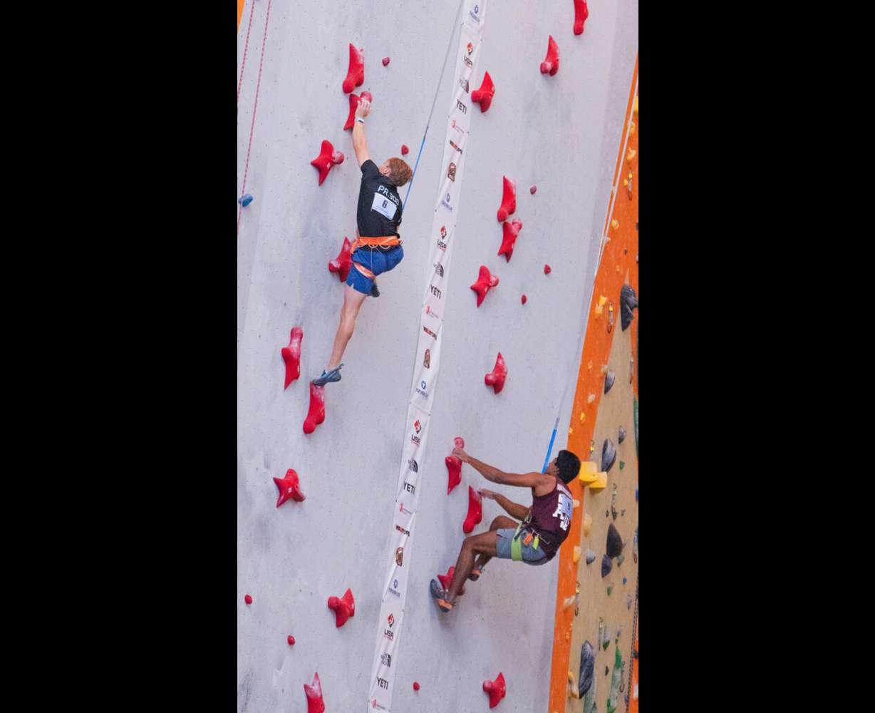 U student Logan Miner (left) competes in the 15-meter advanced men’s speed final at the USA Climbing Collegiate National Championships. Miner placed first, with a time of 5.59 seconds.