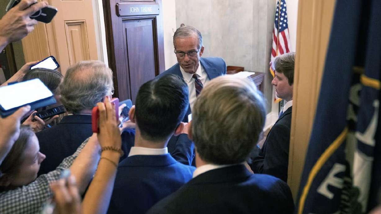 Senate Majority Leader John Thune, R-S.D., talks to reporters at the Capitol, Wednesday, in Washington. The Senate began its marathon session, known as a vote-a-rama, on Thursday morning — which could stretch on for hours.