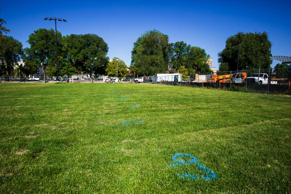 Numbers spray-painted into the ground at Pioneer Park identify where vendors will set up for the Salt Lake City Downtown Farmers Market this year. The market returns this weekend.