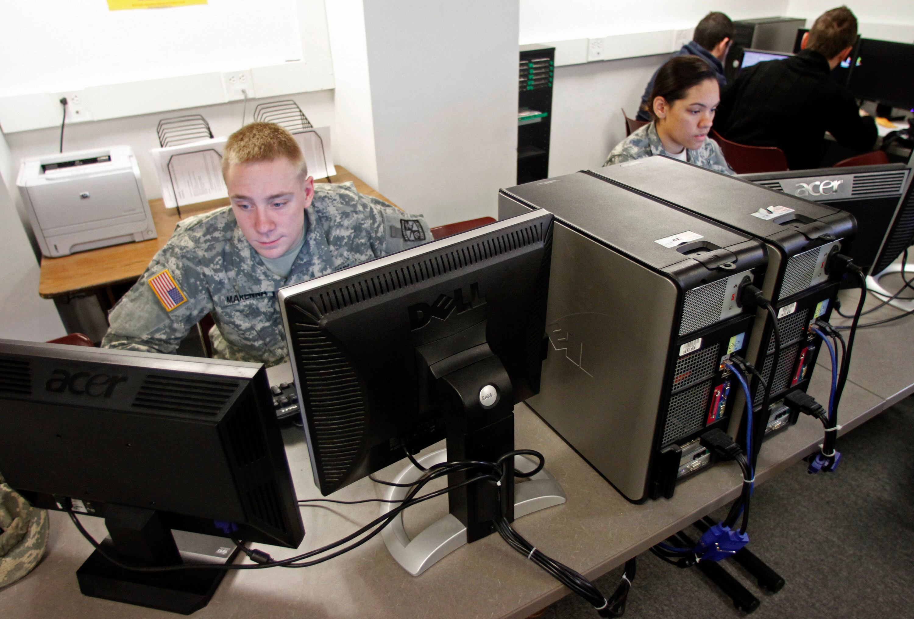 In this March 8, 2012 photo, Norwich University student Adam Marenna, of Belair, Md., works on computers in Northfield, Vt. Deep in the bowels of a building on the campus of the nation's oldest private military academy, students from across the globe are being taught to fight the war of the future. In a six-week seminar nearing its end, students take turns building and defending computer networks, attacking one or monitoring the operation. The technical training is only a part of the skills needed to protect computer networks from probes that could allow an attacker full access to a target computer.