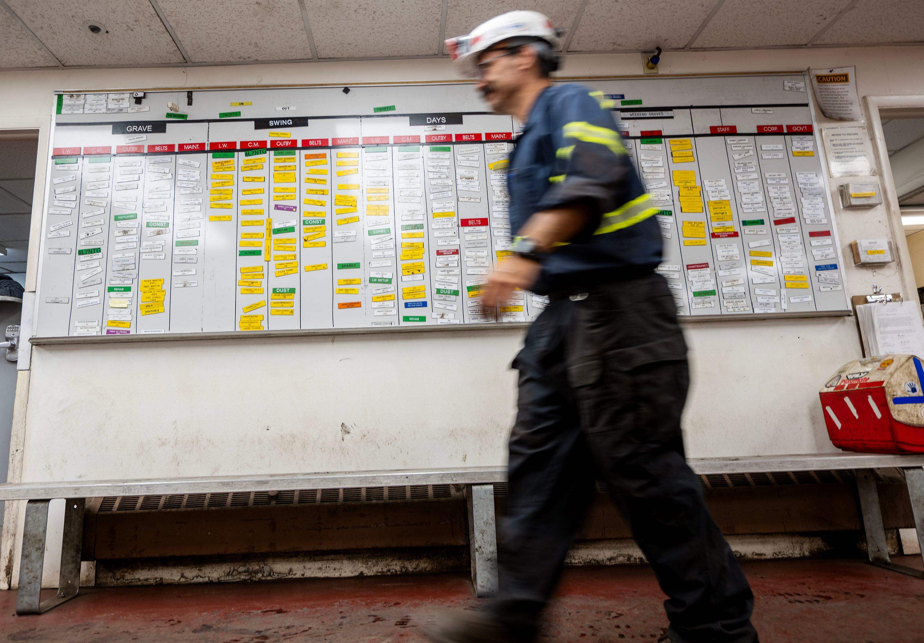 A miner walks past the name board at Sufco Mine, an underground coal mine near Salina, on Aug. 19, 2025.