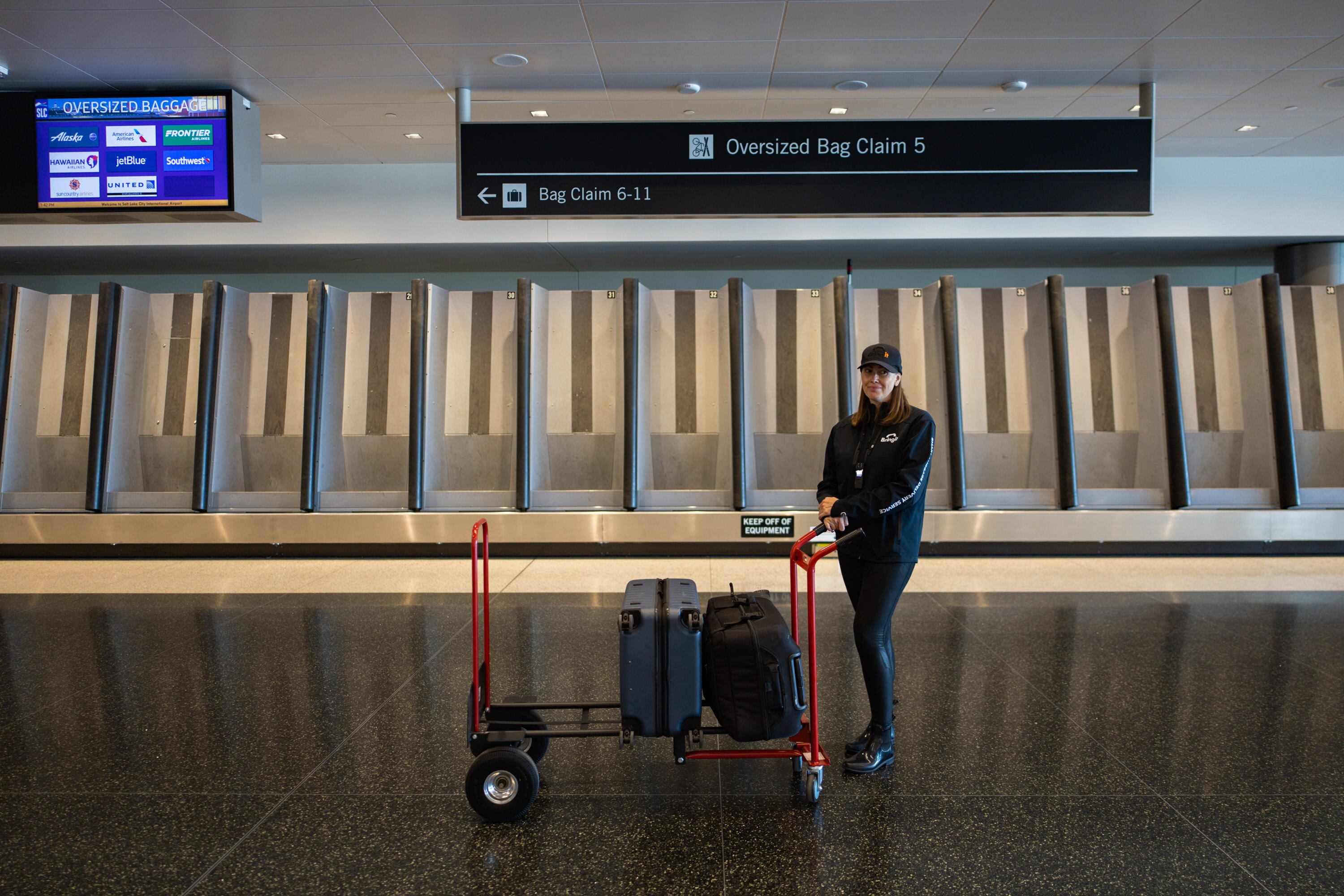 Jeanette Lee, co-founder and chief commercial officer of Bringit, waits to pick up luggage for a customer at Salt Lake City International Airport on Wednesday. Bringit is a company that provides an on-demand, same-day luggage delivery to hotels, rentals and residences in Salt Lake City and Park City.