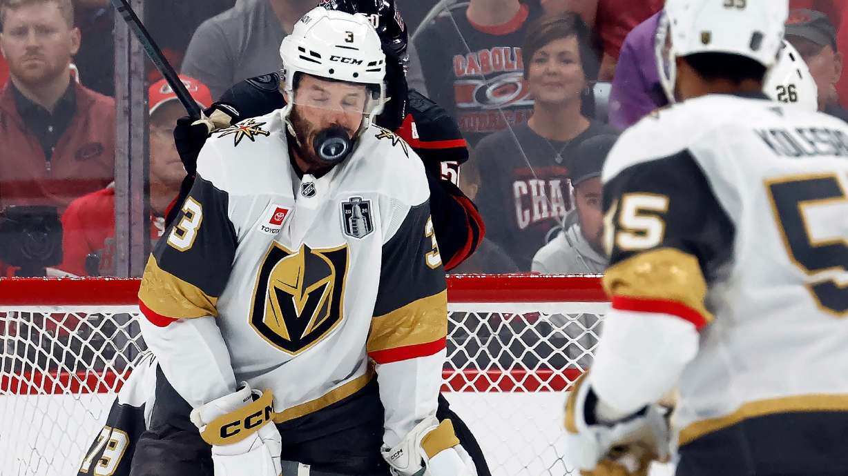 Vegas Golden Knights' Brayden McNabb takes a puck to the face during the first period in Game 2 of the NHL hockey Stanley Cup Final series against the Carolina Hurricanes in Raleigh, N.C., Thursday, June 4, 2026.