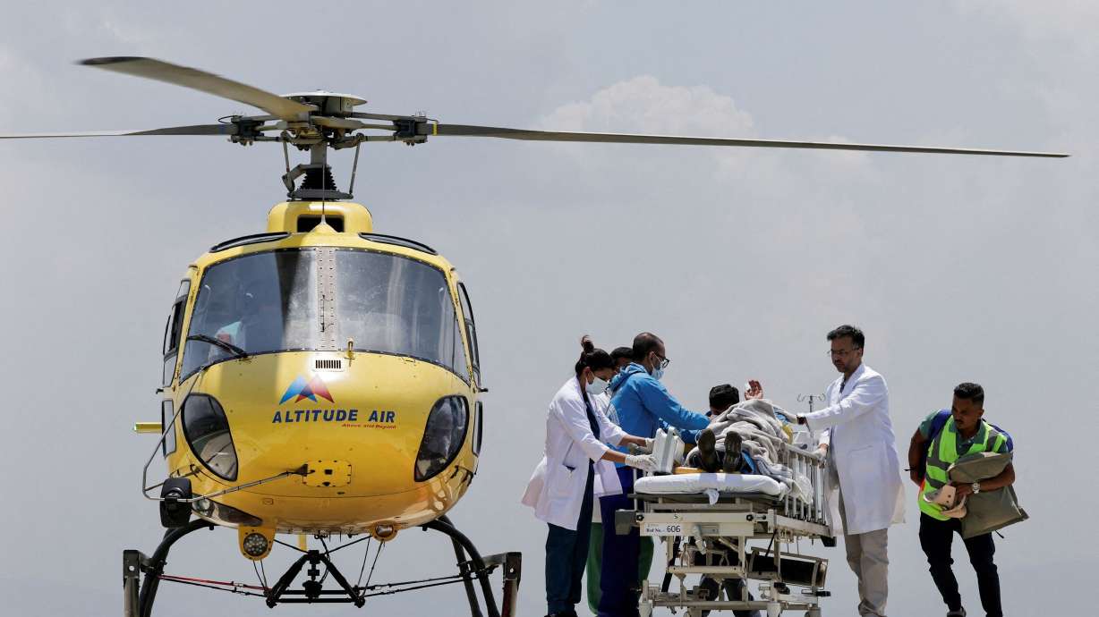 Paramedics transport Dawa Sherpa, who was missing for several days in the Everest region, from the helipad at HAMS Hospital in Kathmandu, Nepal, June 4.