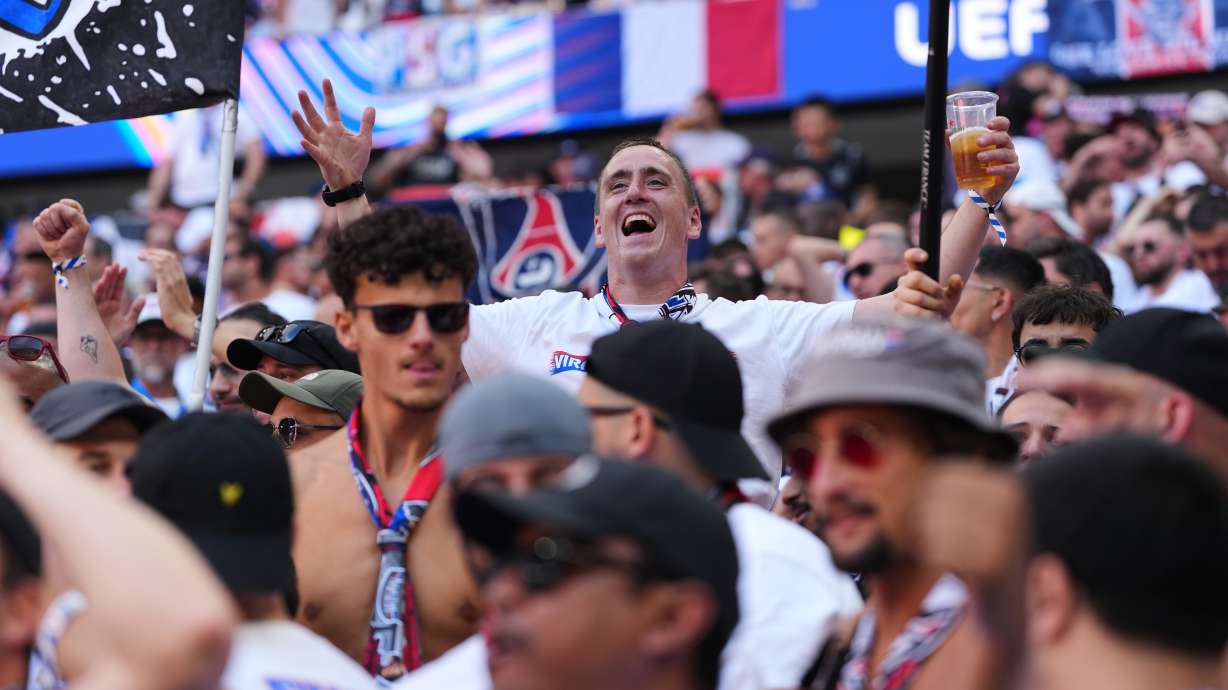 FILE - PSG fans cheer for their team before the Champions League final soccer match between Paris Saint-Germain and Arsenal in Budapest, Hungary, May 30, 2026.