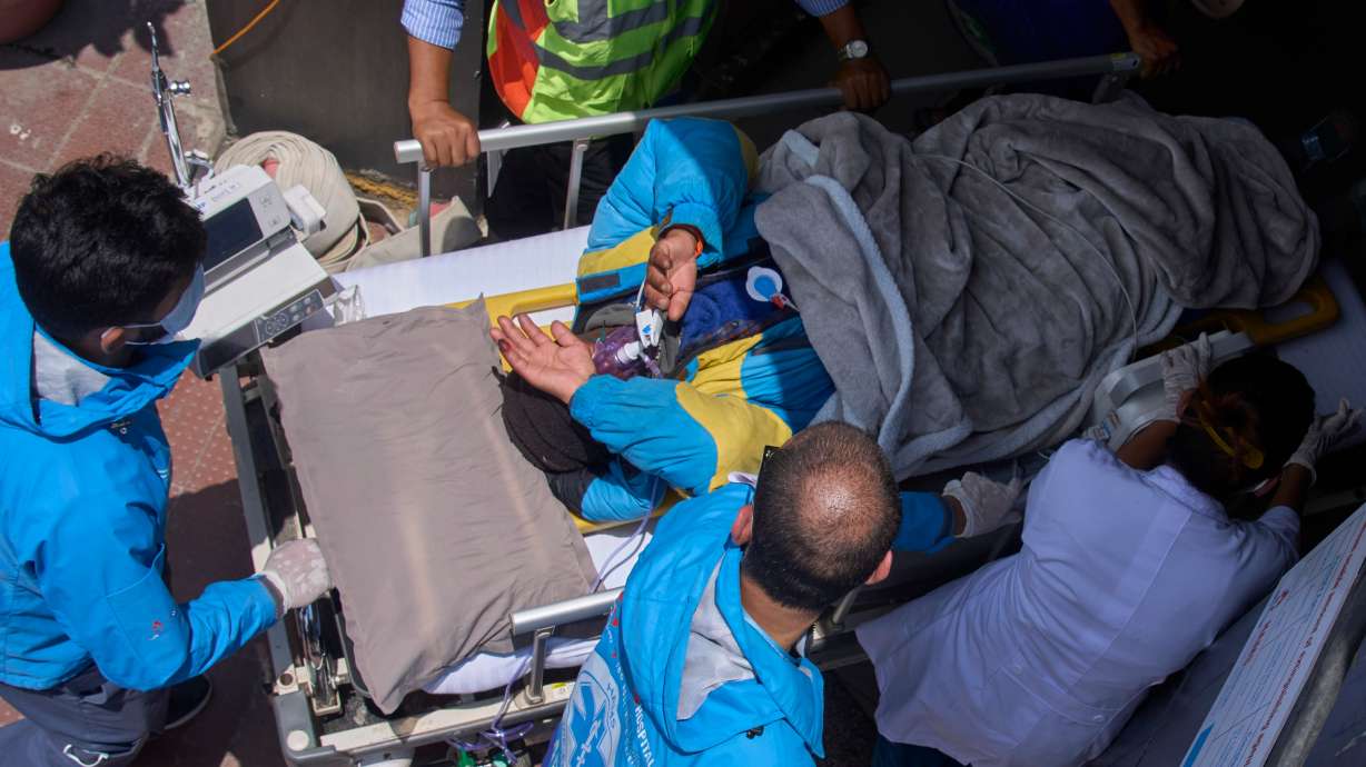 Medics take Dawa Sherpa, a mountain guide who had been missing for several days in the Everest region, for treatment after he arrived at HAMS Hospital in Kathmandu, Nepal, Thursday, June 4, 2026. CORRECTION: Corrects hospital name to HAMS not Grande