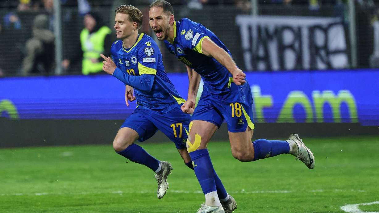 FILE - Bosnia's Nikola Katic, right, and Bosnia's Dzenis Burnic celebrate after winning a penalty shootout during the World Cup qualifying playoff final soccer match between Bosnia and Italy in Zenica, Bosnia, on March 31, 2026.