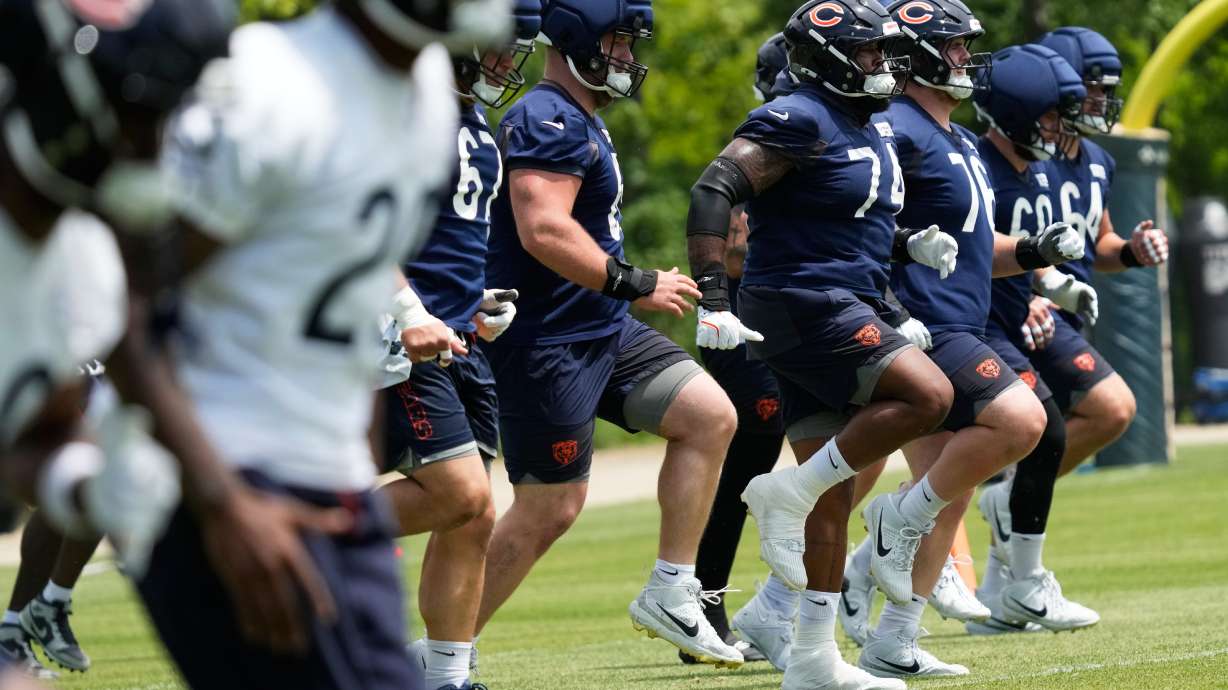 Chicago Bears offensive linemen warm up during the NFL football team's practice Wednesday, June 3, 2026, in Lake Forest, Ill.