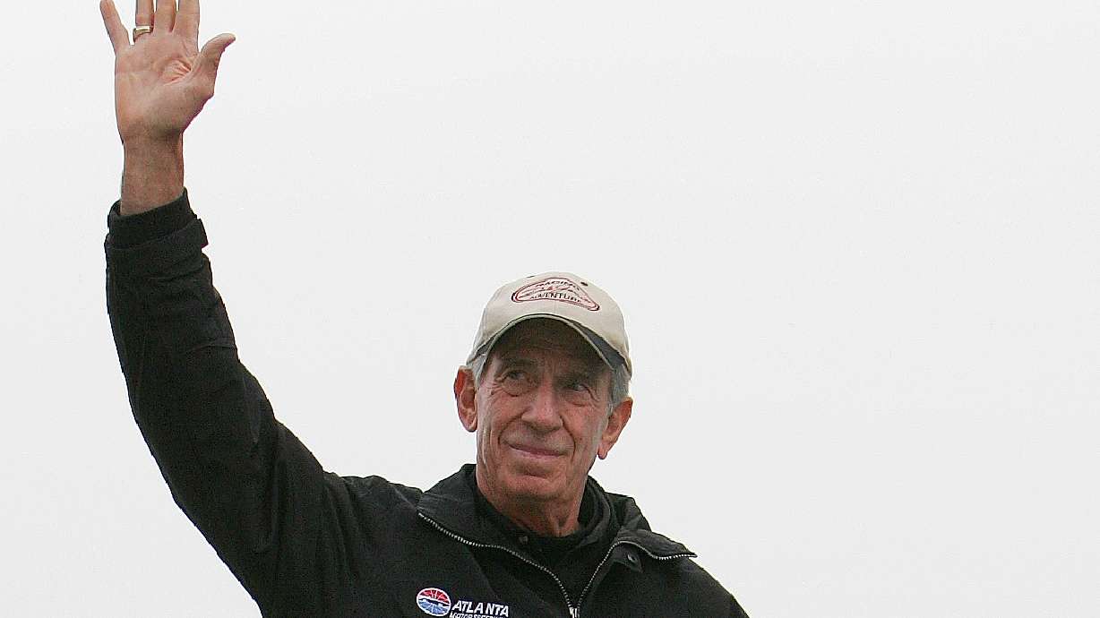 FILE - NASCAR legend Ned Jarrett waves to the fans as he is introduced before the start of the NASCAR BUSCH Nicorette 300 at Atlanta Motor Speedway in Hampton, Ga., March 18, 2006.