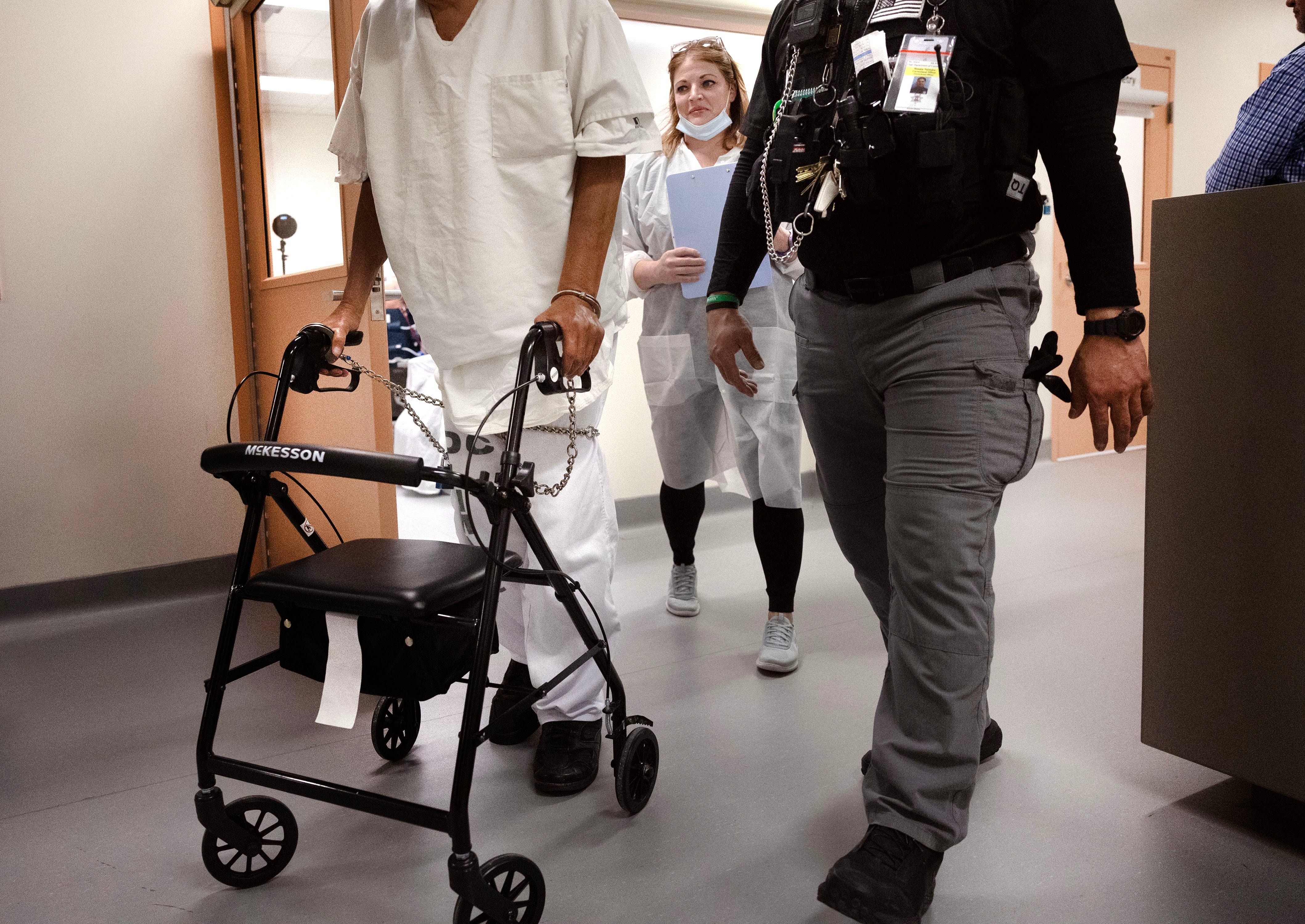 Kelly Kunzler, certified clinical hemodialysis technician, walks with her patient and a corrections officer following a dialysis treatment at the Utah State Correctional Facility in Salt Lake City on Wednesday. The in-house treatment options save taxpayers about $525,000 a year.