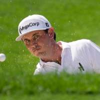 J.T. Poston handles the wind at Memorial for low round of tournament and the lead