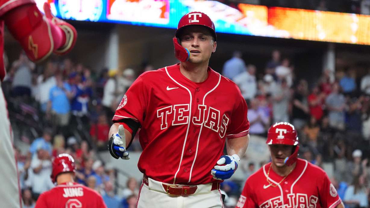 Texas Rangers' Corey Seager, center, jogs to the dugout after hitting a home run during the sixth inning of a baseball game against the Cleveland Guardians, Friday, June 5, 2026, in Arlington, Texas.