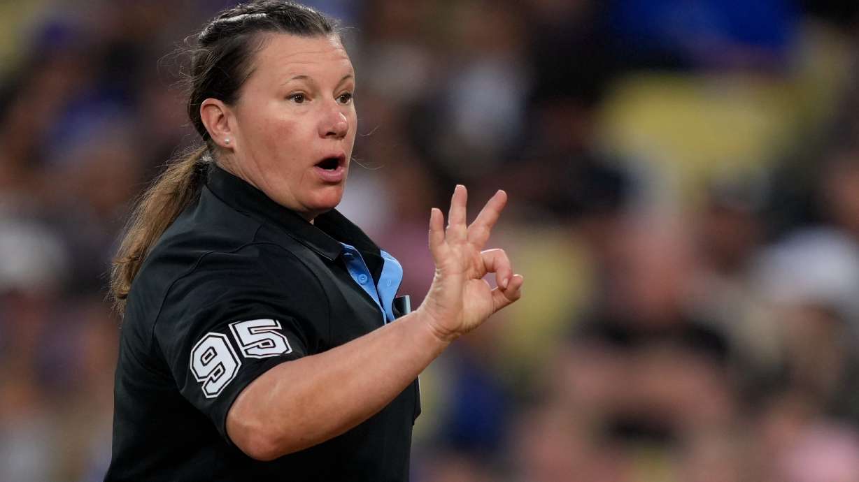 Home plate umpire Jen Pawol asks for more baseballs during the third inning of a baseball game between the Los Angeles Dodgers and the Los Angeles Angels, Friday, June 5, 2026, in Los Angeles.