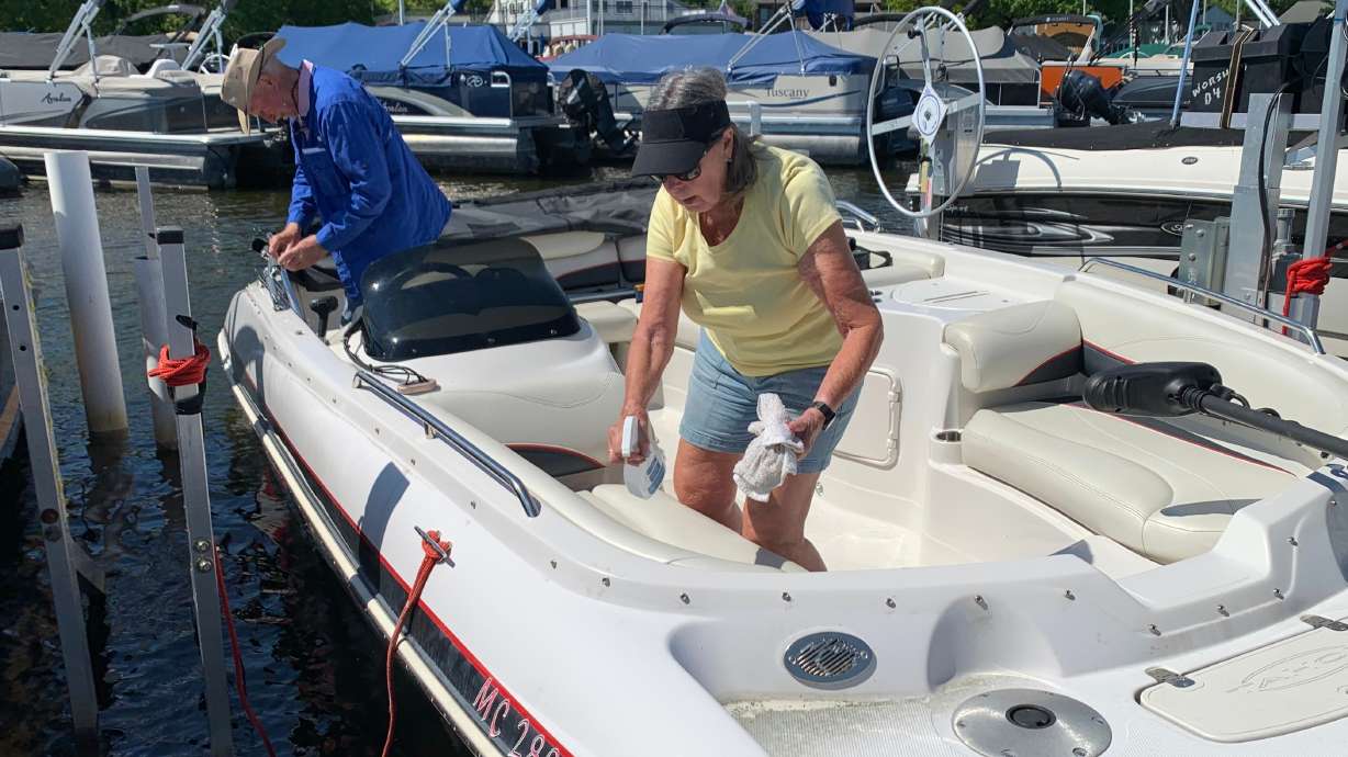 Kay Worsham cleans her boat May 31, in Dexter Township, Mich.