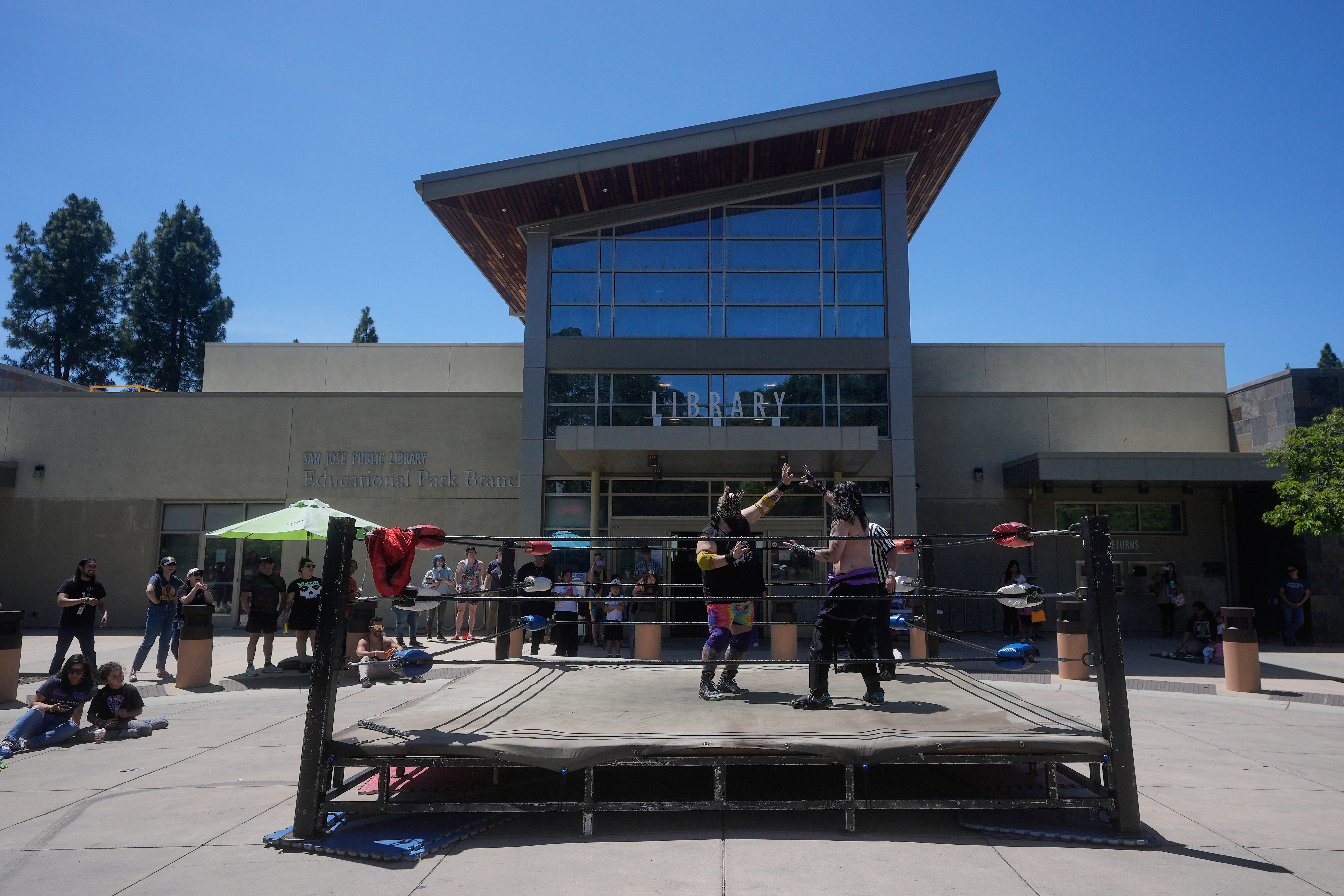 Wrestlers Llama Jack, center left, and Sampiro compete in a Lucha Libro pro wrestling match at the San Jose Public Library Educational Park Branch Saturday, May 9, 2026, in San Jose, Calif. 