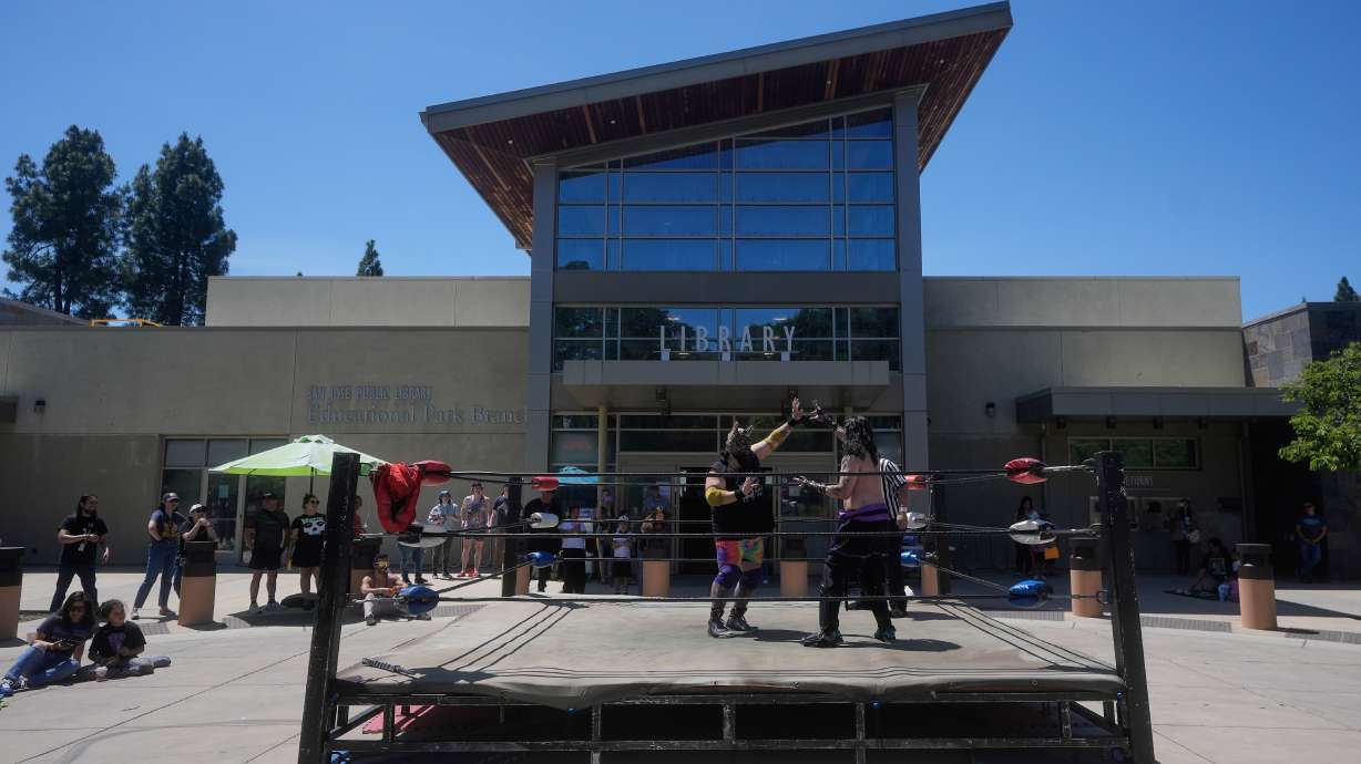 Wrestlers Llama Jack, center left, and Sampiro compete in a Lucha Libro pro wrestling match at the San Jose Public Library Educational Park Branch Saturday, May 9, 2026, in San Jose, Calif.