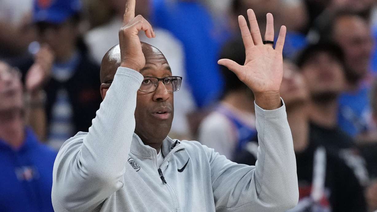 New York Knicks head coach Mike Brown makes a call during the first half of Game 2 of the NBA Finals basketball series against the San Antonio Spurs, Friday, June 5, 2026, in San Antonio.