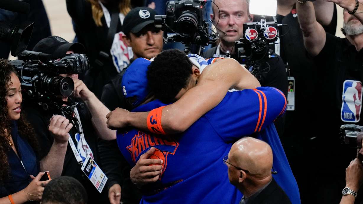 New York Knicks center Karl-Anthony Towns hugs his dad, Karl-Anthony Towns Sr., after Game 2 of the NBA Finals basketball series against the San Antonio Spurs, Friday, June 5, 2026, in San Antonio.