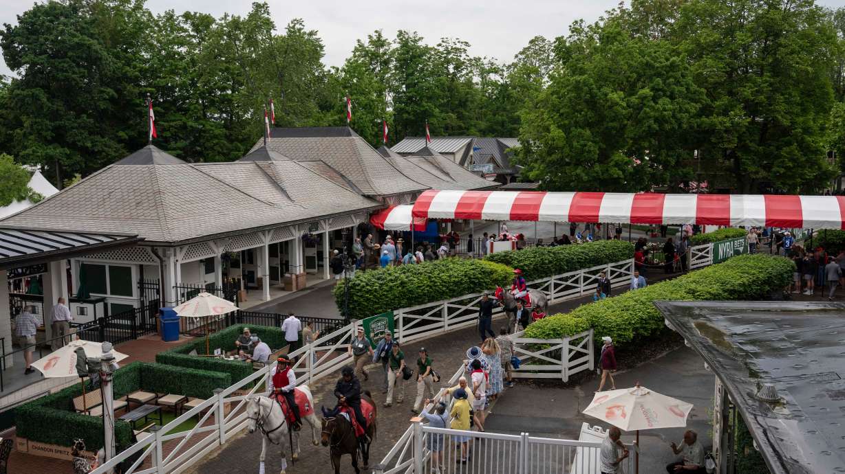Jockeys walk thoroughbreds to the track for the second race of the day before the 158th running of the Belmont Stakes horse race at Saratoga Race Course, Saturday, June 6, 2026, in Saratoga Springs, N.Y.