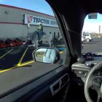 Have You Seen This? Police officer investigates man riding steer in parking lot