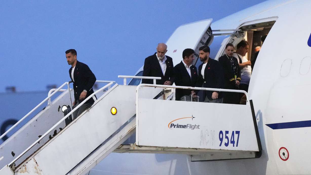 Iran's Ehsan Hajisafi, left, arrives with his teammates for the World Cup soccer tournament in Tijuana, Mexico, Sunday, June 7, 2026.