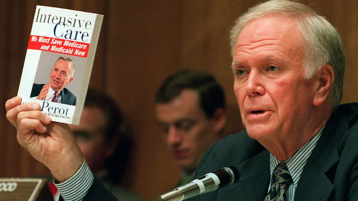 Senate Finance Committee Chairman Bob Packwood, R-Ore., holds a book entitled "Intensive Care" by Ross Perot, during hearings dealing with the future of Medicare on Capitol Hill, Aug. 30, 1995.