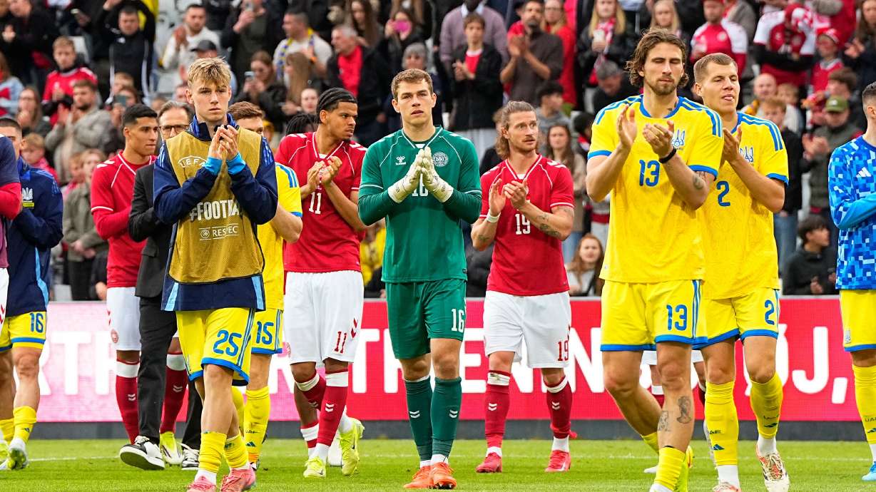 Denmark's and Ukraine's players walk on the pitch after the international friendly soccer match between Denmark and Ukraine was cancelled in Odense, Denmark, Sunday, June 7, 2026, after Christian Eriksen has collapsed on the field again while playing for Denmark’s national team.
