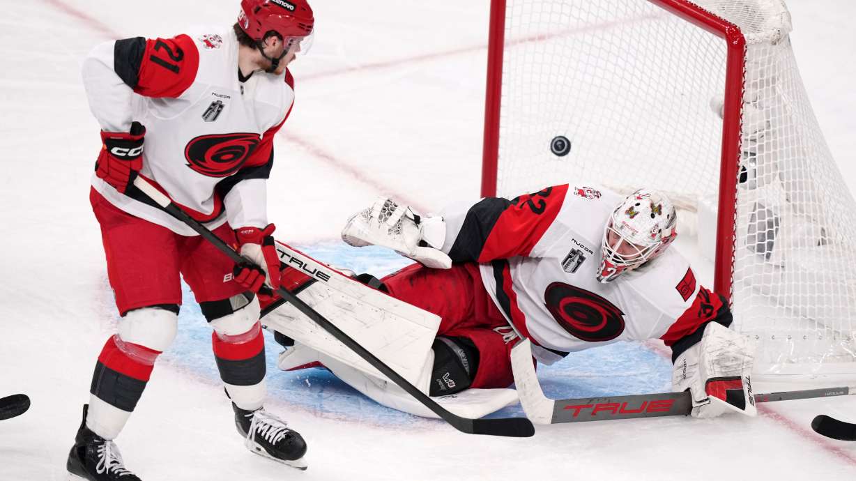 Carolina Hurricanes goaltender Brandon Bussi, right, is scored on by Carolina Hurricanes left wing Nikolaj Ehlers as defenseman Alexander Nikishin watches during the second overtime in Game 3 of the NHL hockey Stanley Cup Final series Saturday, June 6, 2026, in Las Vegas.