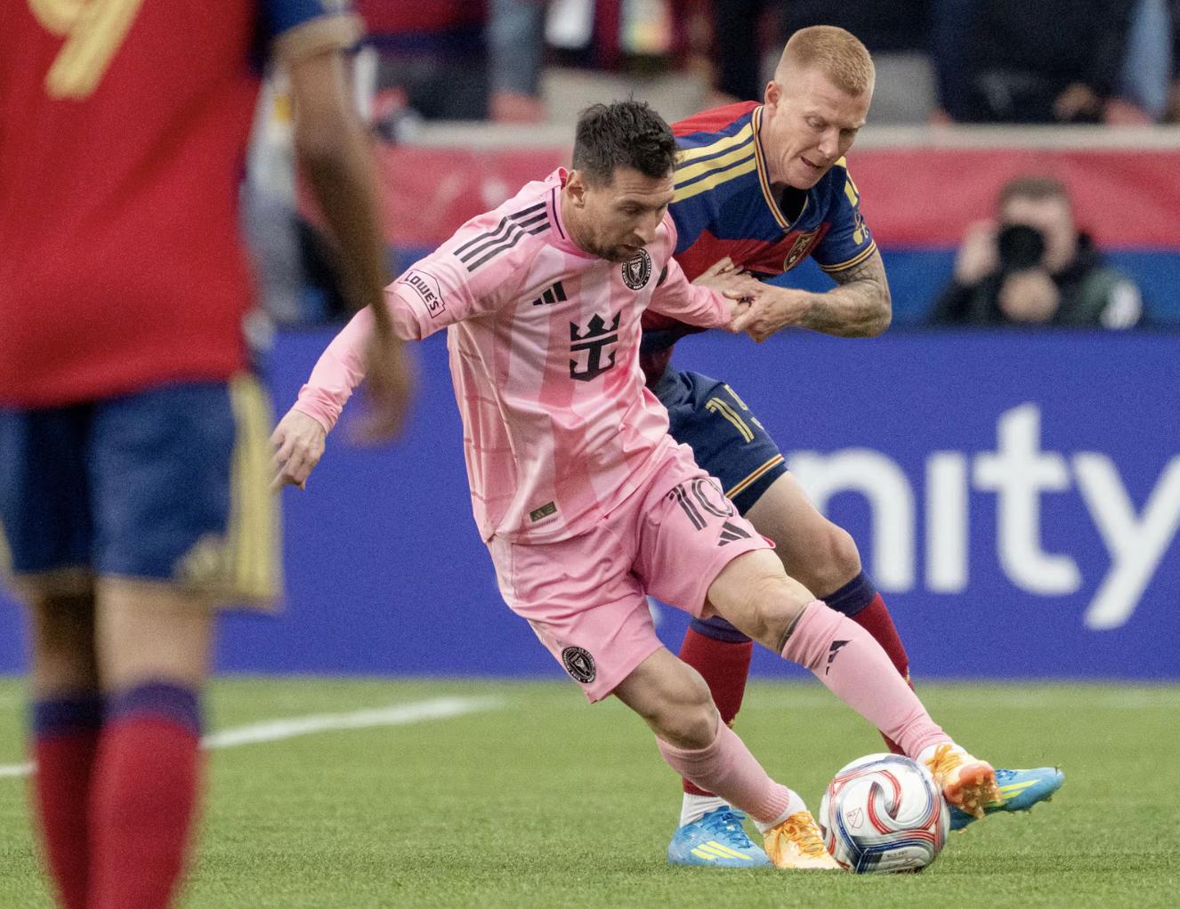 Inter Miami CF midfielder Lionel Messi (10) spins away from Real Salt Lake defender Justen Glad (15) as RSL and Inter Miami play at America First Field in Sandy on April 22, 2026.