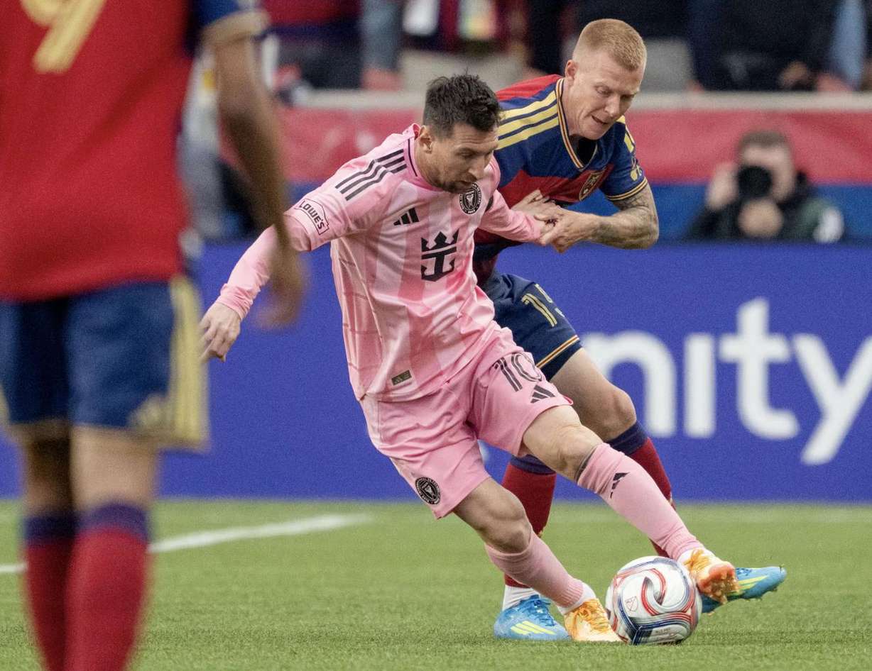 Inter Miami CF midfielder Lionel Messi (10) spins away from Real Salt Lake defender Justen Glad (15) as RSL and Inter Miami play at America First Field in Sandy on April 22, 2026.