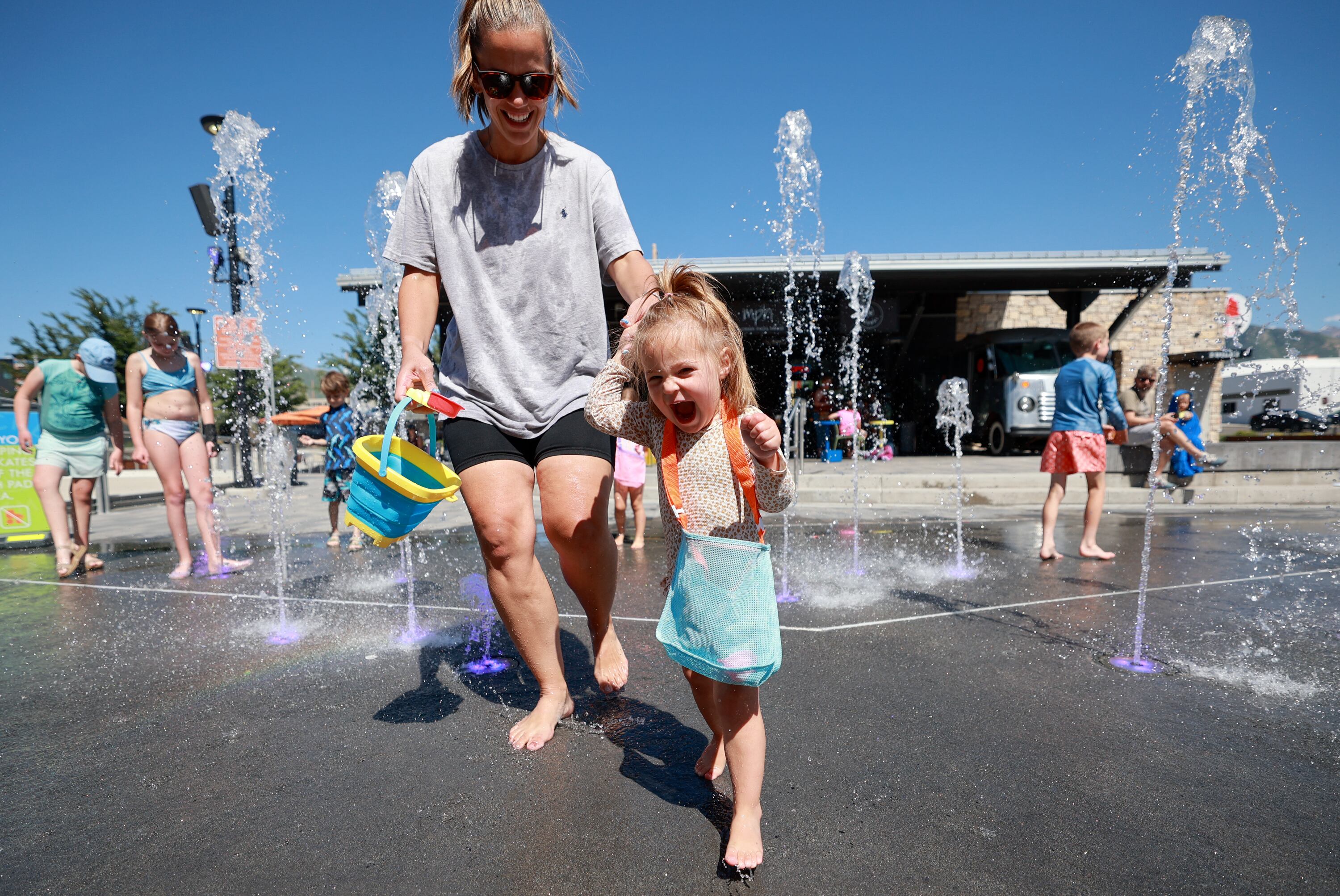Hanna Matekel and Scottie Matekel, 2, play at the Millcreek Common splash pad in Millcreek on Thursday. Hanna Matekel also believes building relationships with her children now is important.