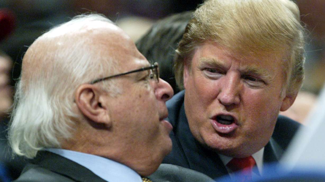 FILE - Donald Trump, right, talks to an unidentified man from the stands at Madison Square Garden during the New York Knicks game against the Dallas Mavericks on Jan. 11, 2006, in New York.