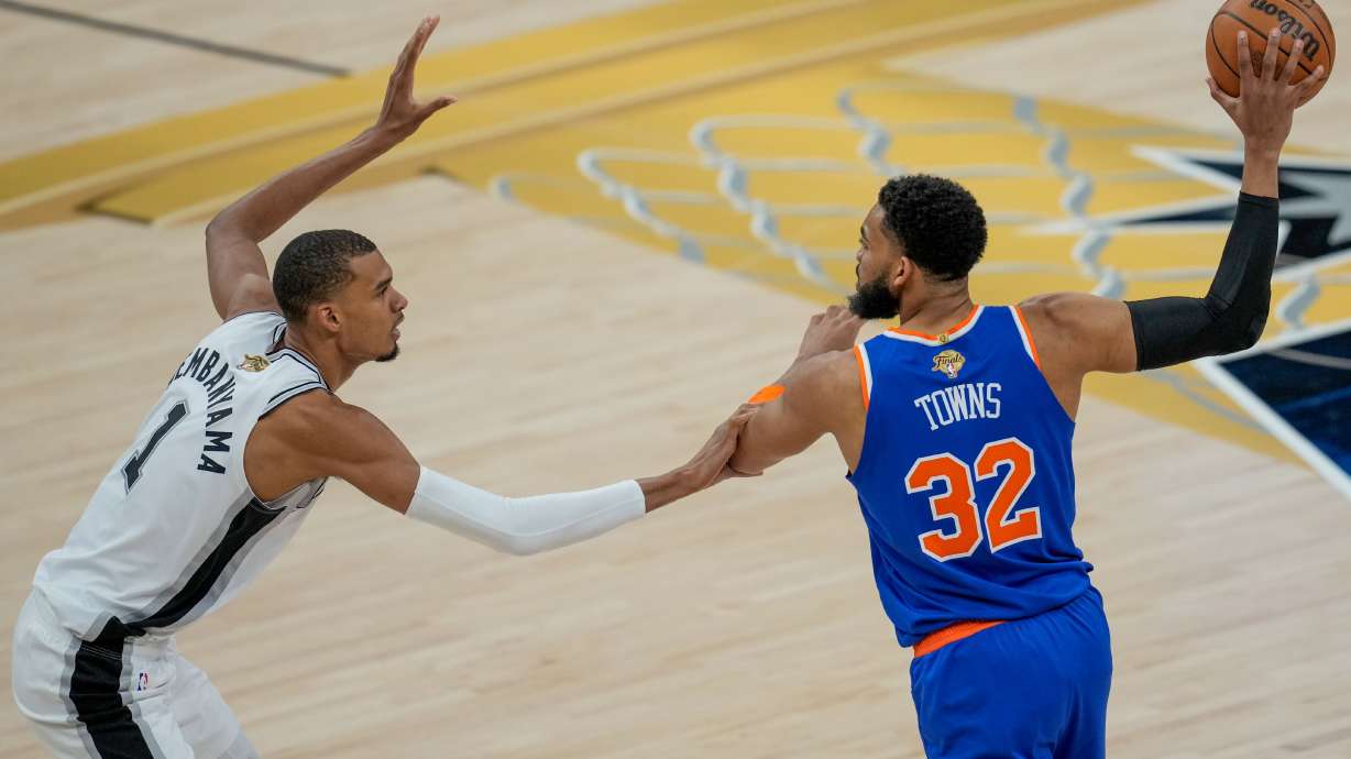 San Antonio Spurs forward Victor Wembanyama (1) defends against New York Knicks center Karl-Anthony Towns (32) during the first half of Game 2 of the NBA Finals basketball series, Friday, June 5, 2026, in San Antonio.
