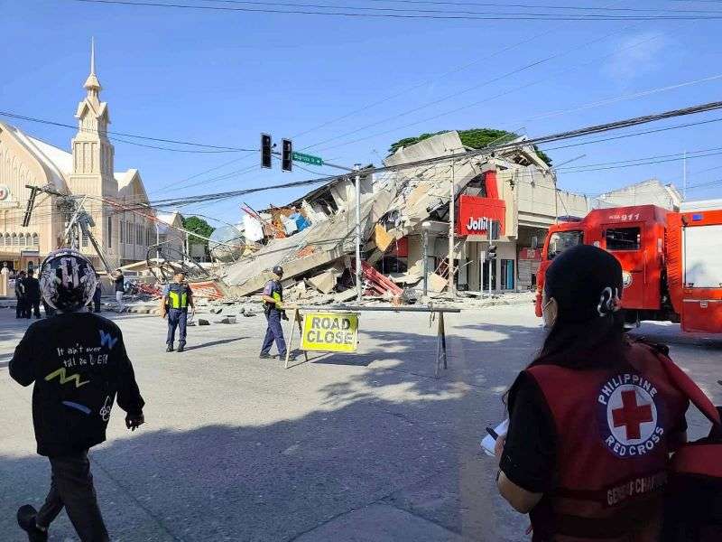 In this photo provided by the Philippine Red Cross, rescuers inspect the damage after an earthquake in General Santos, Philippines on Monday.