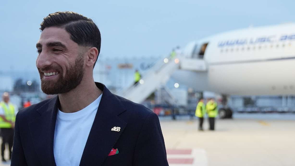 Iran's Alireza Jahanbakhsh smiles as he arrives with his teammates for the World Cup soccer tournament in Tijuana, Mexico, Sunday, June 7, 2026.