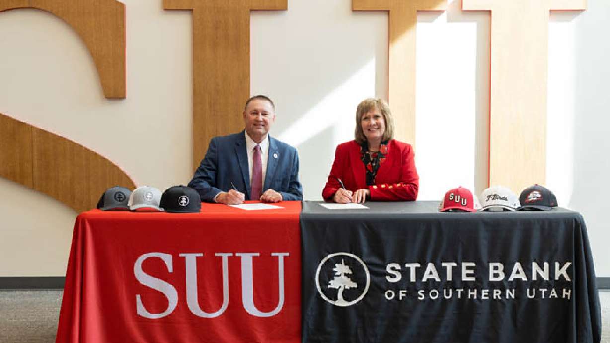 Trevor Andersen, CEO and president of State Bank of Southern Utah, left and Mindy Benson, Southern Utah University president, right, pose for a picture. SUU last week announced a 15-year sponsorship with State Bank of Southern Utah.