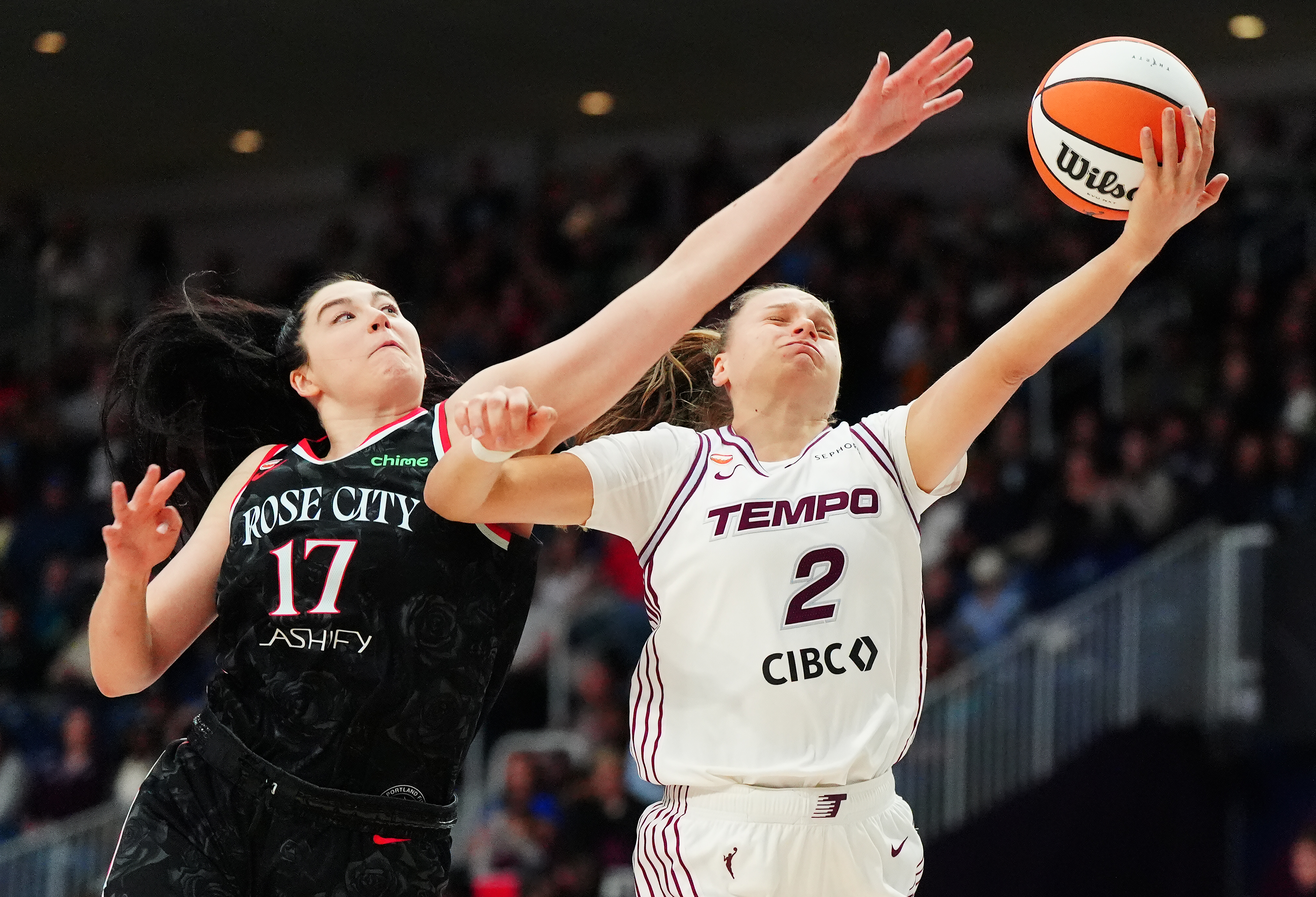 Portland Fire's Megan Gustafson (17) fouls Toronto Tempo's Laura Juskaite (2) during second-half WNBA basketball game action in Toronto, Saturday May 23, 2026. 