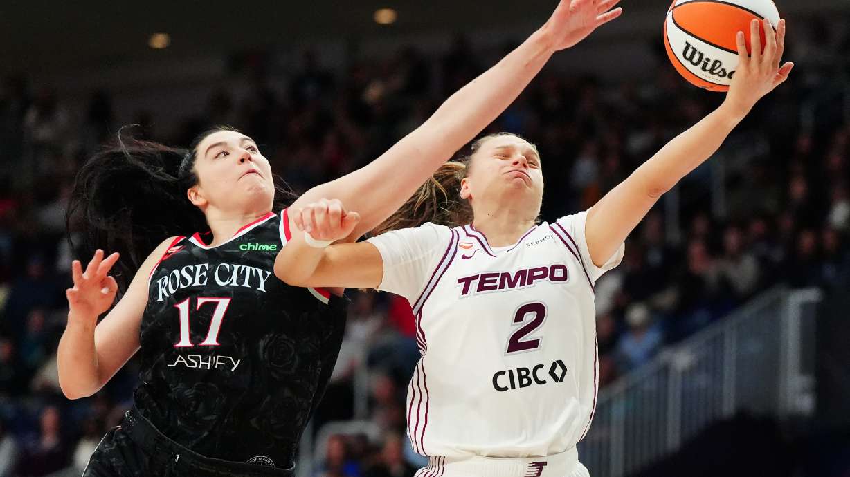 Portland Fire's Megan Gustafson (17) fouls Toronto Tempo's Laura Juskaite (2) during second-half WNBA basketball game action in Toronto, Saturday May 23, 2026.
