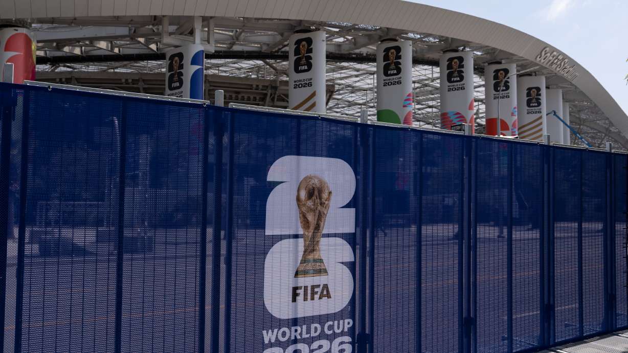 Temporary fencing with FIFA World Cup 2026 signage is set up outside SoFi Stadium, Friday, June 5, 2026, in Inglewood, Calif.